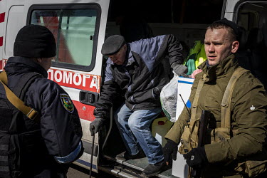 An elderly man arrives in an ambulance at an aid station in north west Kyiv, having being evacuated from the besieged town of Irpin.