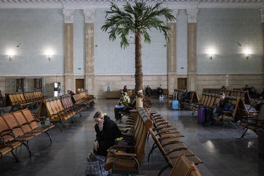 People who have fled their homes in various parts of Ukraine wait in a reception area at Kyiv central station before travelling onward.