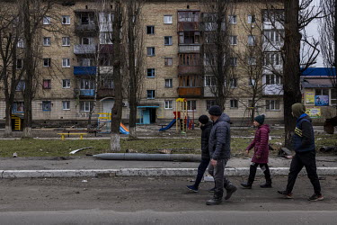 People walk past a missile casing in the battle scarred small town of Borodianka where, according to the acting mayor, as many as 200 people are missing, presumed dead, still lying under the rubble le...
