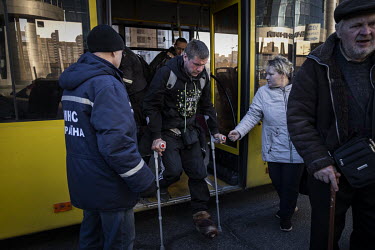 People arrive at Kyiv central train station having being evacuated, through Russian controlled territory, from the besieged town of Bucha in the suburbs of northwestern Kyiv.