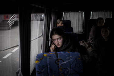A young woman makes a call on a mobile phone as she arrives in the relative safety of Kyiv, having managed to escape the besieged city of Chernihiv.