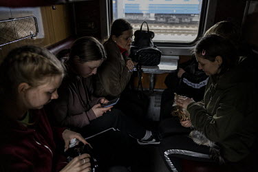 The Revenok family and their friends who all escaped Chernihiv together now wait to depart by train from Kyiv for Lviv, from where they plan to travel on into Europe. They managed to escape the besieg...