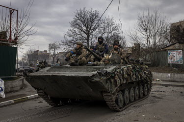A column of Ukrainian armoured fighting vehicles and tanks moves through the recently liberated town of Bucha.