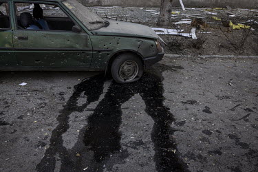 A damaged car outside an apartment block, after it was struck in a Russian multiple rocket attack in the Nyvky district of western Kyiv early that morning.