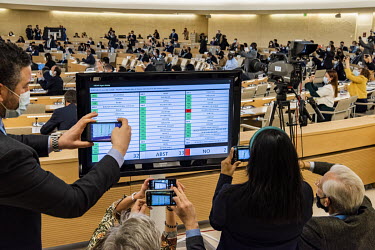 Members of press and diplomats photographing the results of the vote following the emergency debate on Ukraine at the UN Human Rights Council in the week following the invasion by Russia.