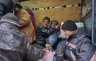 People squeeze onto evacuation transport to leave the city using a minibus organised by volunteers from SOS Vostok. The evacuees have been hiding in basements for at least two or three weeks, enduring...