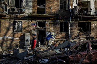 As sunset approaches, residents sift through debris looking for salvageable belongings in a residential area of north western Kyiv. The bombardment by Russian forces caused considerable damage to seve...