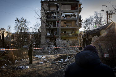 As sunset approaches, residents sift through debris looking for salvageable belongings in a residential area of north western Kyiv. The bombardment by Russian forces caused considerable damage to seve...