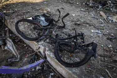 A burned bicycle lies outside a bomb-damaged residential apartment block in north western Kyiv. The bombardment by Russian forces caused considerable damage to several apartment blocks and a nearby sc...