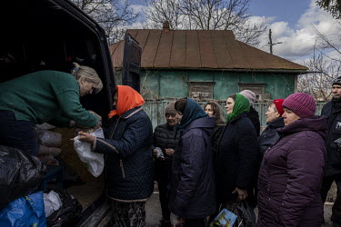 Women queuing for food aid in the recently liberated village of Nova Basan, that had been under Russian forces control for nearly one month.