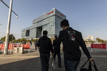 Pedestrians walk towards the JD.com Inc. headquarters. JD.com is China's second-largest online platform and has so far seemed to have avoided the Chinese government's crackdown on its tech giants.