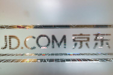 The logo for JD.com Inc. is displayed on a pane of glass at the company's headquarters. JD.com is China's second-largest online platform and has so far seemed to have avoided the Chinese government's...