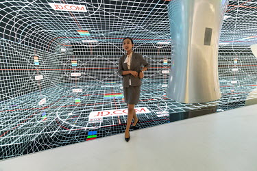 An employee walks past a digital screen at a showroom inside the JD.com Inc. headquarters. JD.com is China's second-largest online platform and has so far seemed to have avoided the Chinese government...