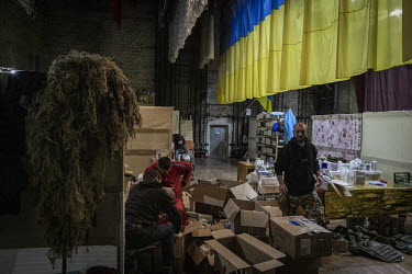 Members of the NGO Vidsich, meaning Rebuff, that is now part of the Territorial Defence Forces, sort military supplies at the organisation's headquarters.