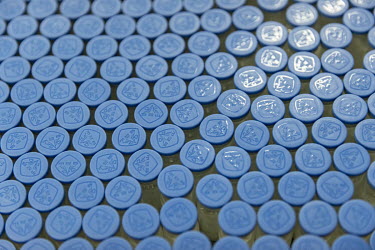 Vials of antibiotics move along a conveyer system on a production line at Guangzhou Pharmaceutical Holdings Ltd.'s Baiyunshan plant.
