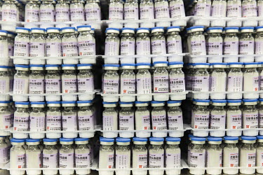 Vials of antibiotics on a shelf on a production line at Guangzhou Pharmaceutical Holdings Ltd.'s Baiyunshan plant.