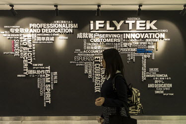 An employee passes a display inside Iflytek Co.'s regional headquarters. Iflytek, which specialises in voice recognition, has been blacklisted by the U.S. government on the 'Entity List' for human rig...