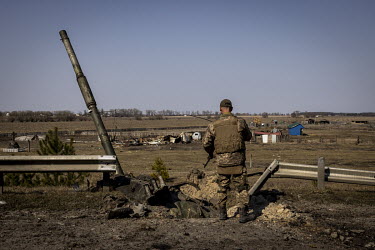 A Ukrainian soldier looks at the remnants of a Russian T90 tank, that was said to have been destroyed using a British-made Javelin missile, at a frontline position in the northern region of Kyiv.