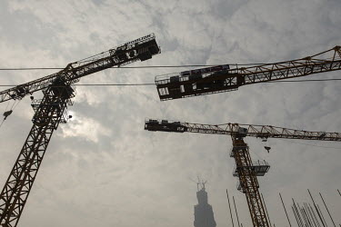 Construction cranes at a development site.