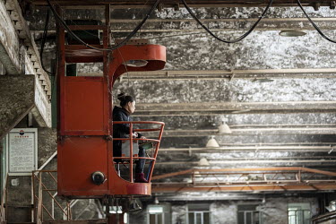 A worker drives a moving crane at the fermentation facility of the Kweichow Moutai Co. liquor factory in the town of Maotai in Renhuai. First favoured and promoted by former Chinese premier Zhou Enlai...