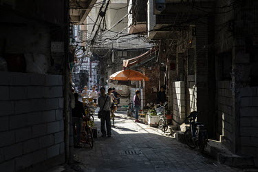 A resident wakls through Xi Cun, an old neighbourhood slated for demolition and redevelopment.