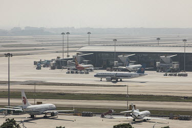 Aeroplanes sit on the tarmac at the Baiyun International Airport.