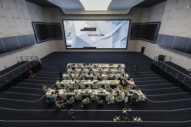Employees work in front of computers in a testing facility at the EHang Inc. headquarters. The Chinese startup has developed a flying car that it plans to roll out as soon as 2018. The E-184 drone can...