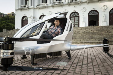 Hu Huazhi, founder and chief executive officer of EHang Inc., seated inside the company's E-184 drone at the EHang Inc. headquarters. The Chinese startup has developed a flying car that it plans to ro...