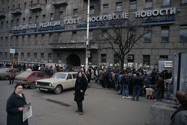 People gather outside the Moscow News building to discuss current affairs.