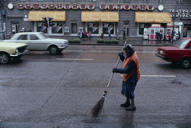A street cleaner working on a rainy day.
