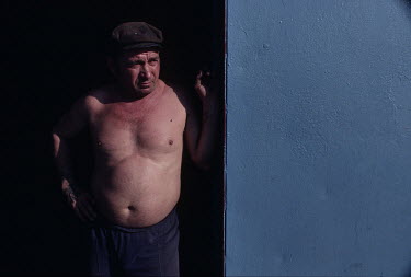A coal miner stands in a doorway in a sprawing neighbourhood where many miners live near the mines. Ukrainian coal miners went on strike for political change at the Kremlin, contributing to the dissol...
