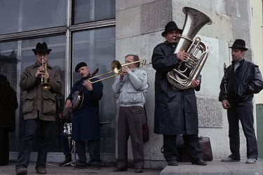 A Dixieland jazz band plays at an open air street market.