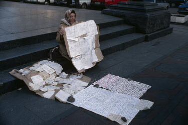 A woman evicted from state housing for political reasons, showing the numerous letters she has written to authorities, appeals for a solution and help in the street.