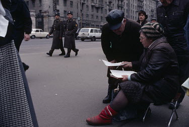 A woman who is part of a collective attempting to gather one million signatures for political change in the Soviet Union on the streets of the capital.