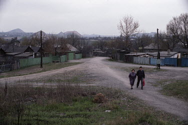 A couple walking near housing at the Chaikina coal mine where Ukrainian coal miners went on strike seeking political change at the Kremlin and contributing to the dissolution of the Soviet Union.