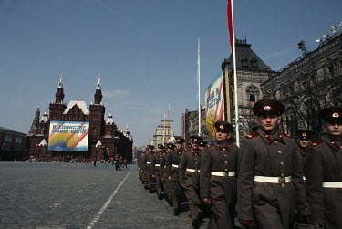 Soldiers march past government buildings on Red Square.