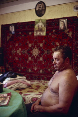Vladimir, a coal miner, in the front room of his home where a picture of Stalin hangs on a wall. Ukrainian coal miners went on strike for political change at the Kremlin, contributing to the dissoluti...