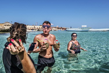 Tourists drinking cocktails in the sea in Hurgarda, a Red Sea resort popular with tourists from Russia and Eastern Europe.