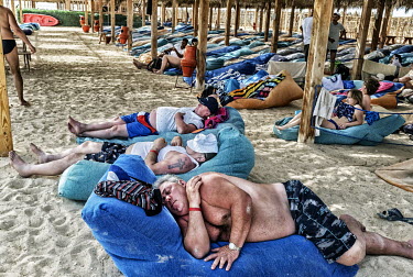 Tourists sleeping beneath a beach shelter in Hurgarda, a Red Sea resort popular with tourists from Russia and Eastern Europe.