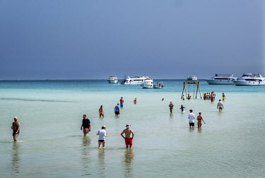 Tourists wade in the shallow waters at a beach resort in Hurgarda, a Red Sea resort popular with tourists from Russia and Eastern Europe.