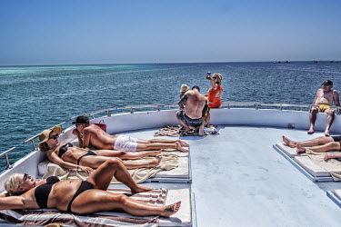 People sunbathe on the deck of a yacht taking tourists on a pleasure cruise from Hurgarda, a Red Sea resort popular with tourists from Russia and Eastern Europe.