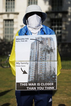 A protestor against the Russian invasion of Ukraine holds a poster during a rally in Whitehall.