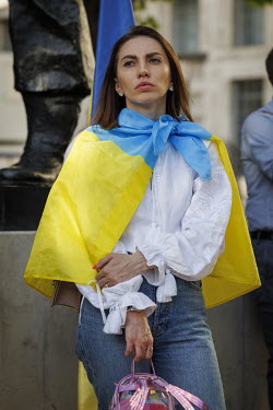 A woman wrapped in a Ukrainian flag during a protest in Whitehall against the Russian invasion of Ukraine.