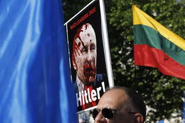 At a protest in Whitehall against the Russian invasion of Ukraine, a person holds a placard that equates Putin with Hitler.