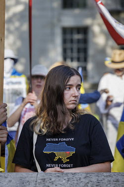 A woman wearing a t-shirt with 'Never Forgive, Never Forget' and a Ukrainian map during a protest in Whitehall against the Russian invasion of Ukraine.