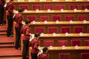 Attendants fill tea mugs with hot water in the Great Hall of the People ahead of the opening of the first session of the 13th Chinese People's Political Consultative Conference (CPPCC).