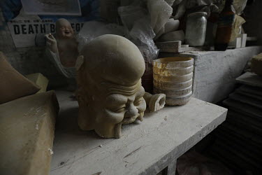Clay works sit on a shelf inside a workshop at the Jingdezhen Porcelain Factory.