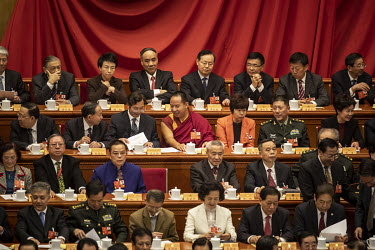 The 13th Panchen Lama, one who is officially recognised by the Chinese government, sits and chats with other delegates in the Great Hall of the People ahead of the opening of the first session of the...