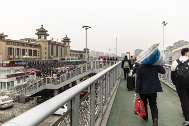 Passengers walk towards the old Beijing train station.