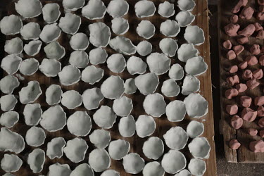 Clay works sit on a shelf inside a workshop at the Jingdezhen Porcelain Factory.